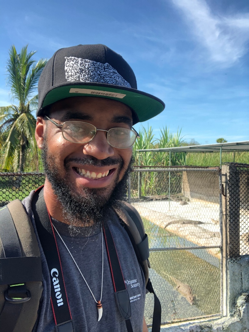 Karl Guyton II standing in front of an alligator enclosure. Photo provided by Karl Guyton II