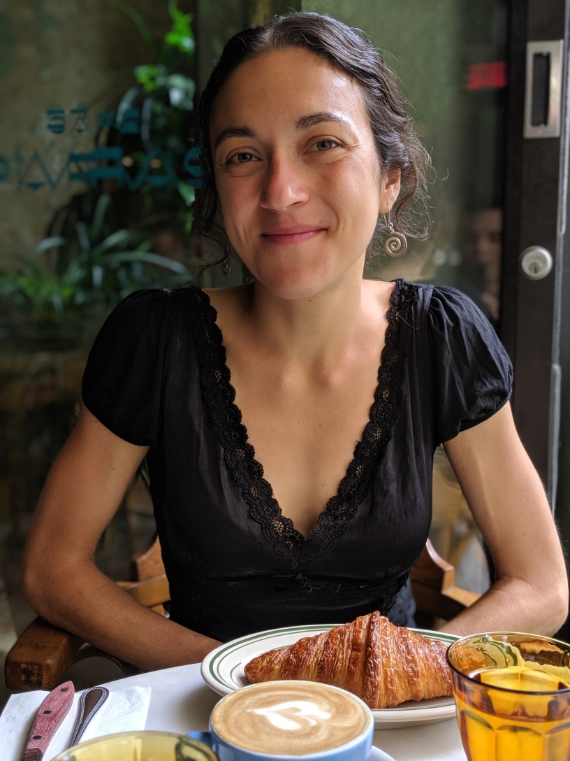 Valentina Borghesani with a croissant and latte in front of her on a table. Photo provided by Valentina Borghesani